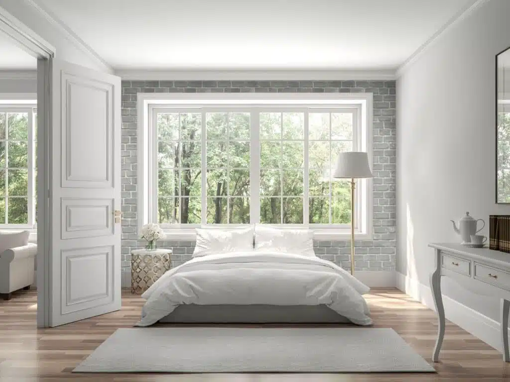 Intérieur d'une chambre à coucher avec un mur en brique gris clair