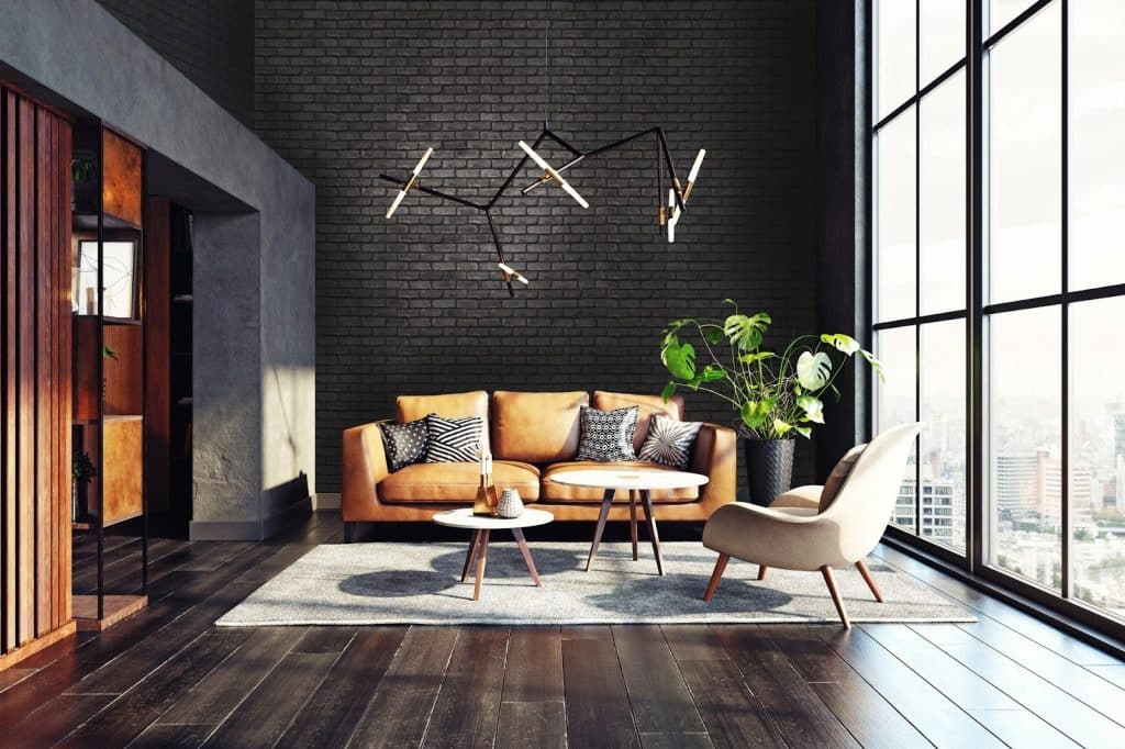 Salon réalisé par Vertika Design avec un mur en briques de couleur gris foncé